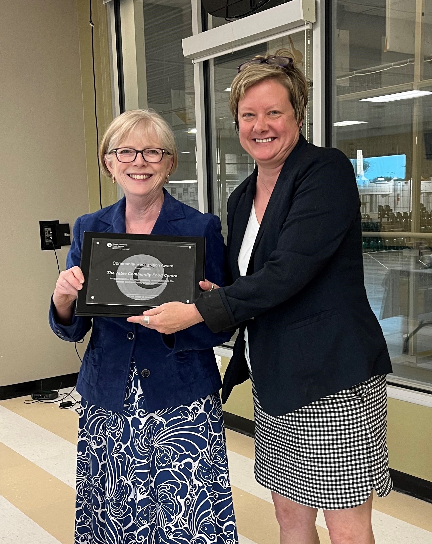 Sandra Shaw, RCHS Board Secretary, presents Lori Taylor, The Table Community Food Centre Board Member, with RCHS' annual Community Recognition Award at the June 27, 2023 Annual General Meeting.